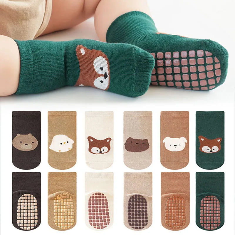 Children's socks with animal designs and textured soles, displayed with a white background.